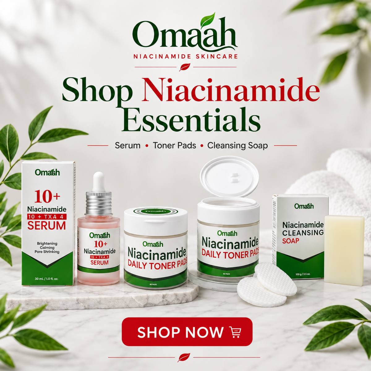 Promotional banner for Omaah Niacinamide Skincare showing several products on a marble surface with decorative leaves and a towel: serum, toner pads, cleansing soap, and a boxed cleanser. Large text reads 'Shop Niacinamide Essentials' with a red 'SHOP NOW' button.